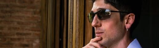 pexels-photo-36104305-36104305 Profile of a contemplative man in sunglasses gazing out a window.